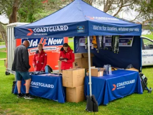 Coastguard uses a branded gazebo and table cover at outdoor