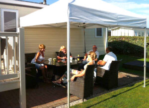people entertaining and sitting in a portable gazebo