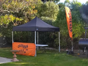 A black gazebo used in an Auckland BBQ event