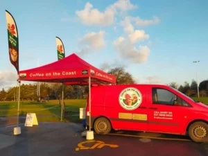 A red branded gazebo with flags for Cafe4U