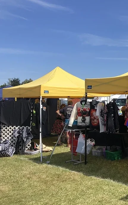 Two yellow pop up gazebos in an Auckland event