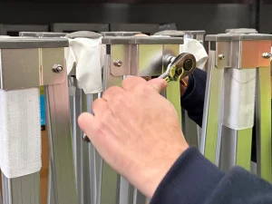 Hands fitting a replacement leg onto a Hercules gazebo frame
