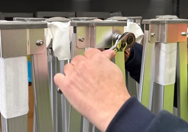 Hands fitting a replacement leg onto a Hercules gazebo frame