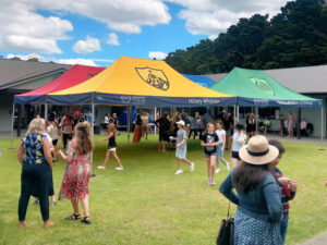 Multiple matching branded school gazebos set up at a New Zealand school gala