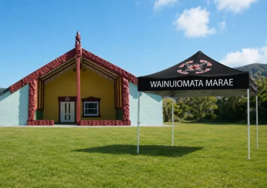 Custom-branded gazebo with Māori cultural insignia set up at a New Zealand community outdoor gathering