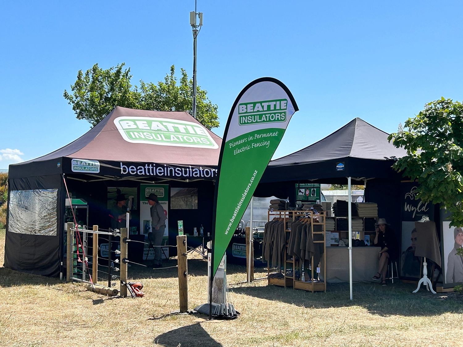 Branded gazebo visible from across busy New Zealand A&P show grounds among other exhibitors
