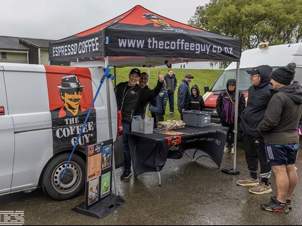 Coffee Guy Petone logoed Hercules gazebo standing out among vendor gazebos at a Wellington outdoor event