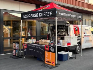 Coffee Guy Petone branded Hercules gazebo set up alongside the coffee van at a Wellington outdoor event